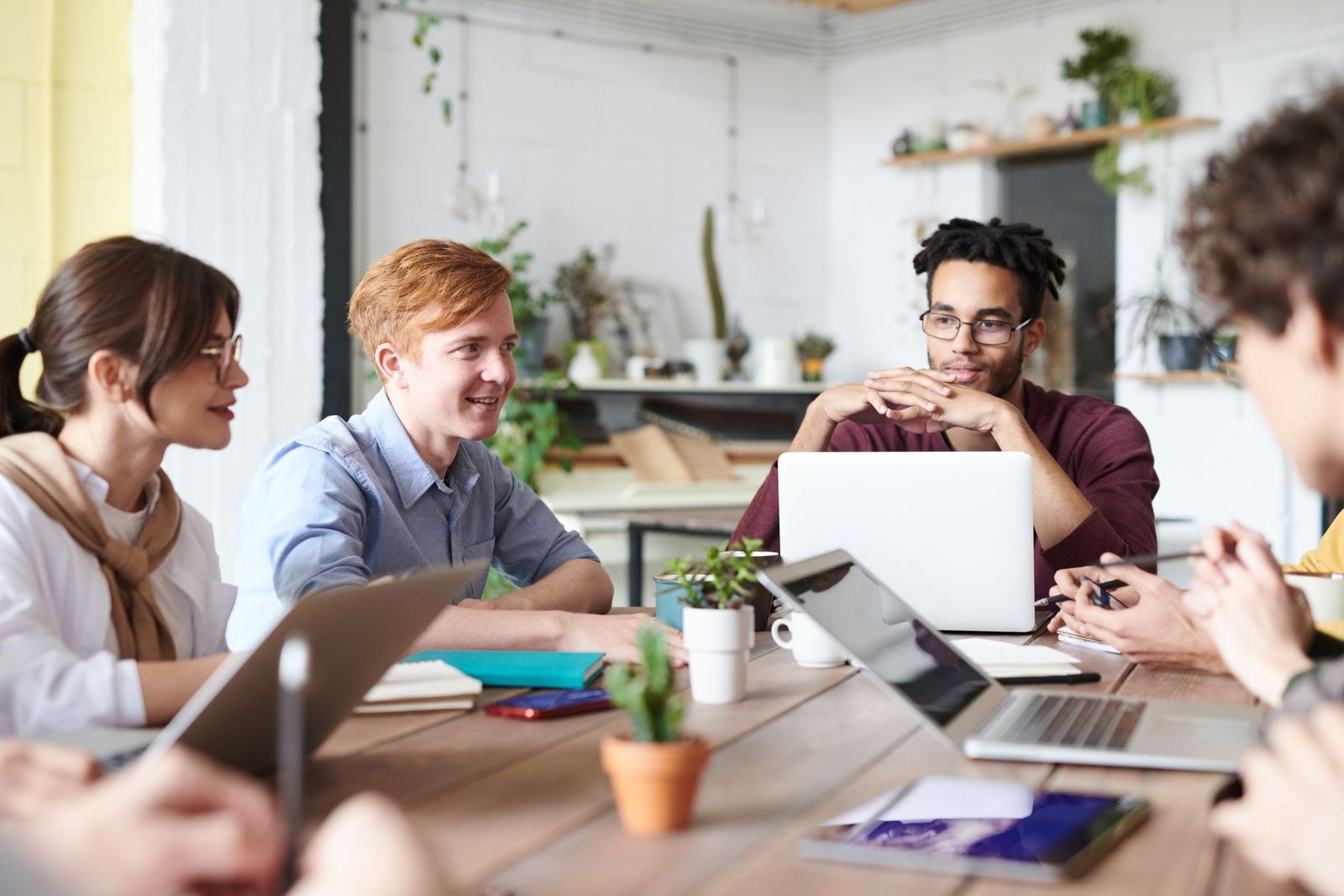 A small business team discussing work around a table